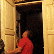 Мастер устанавливает двухстворчатую вторую входную дверь в квартире старого фонда